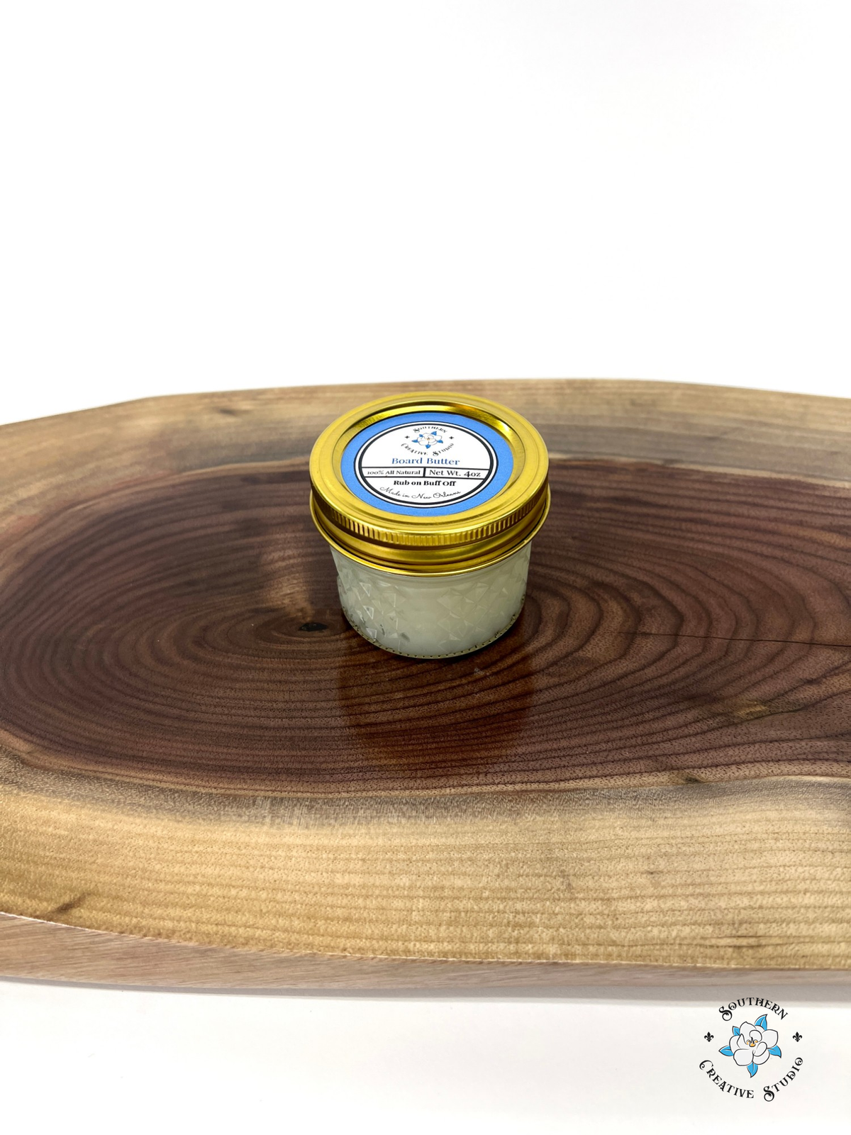 Board Butter wood conditioner jar on a live-edge walnut serving board