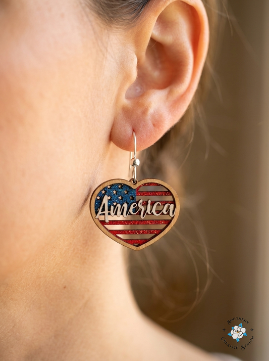 Close up of America Heart hand-painted wood flag earring on ear