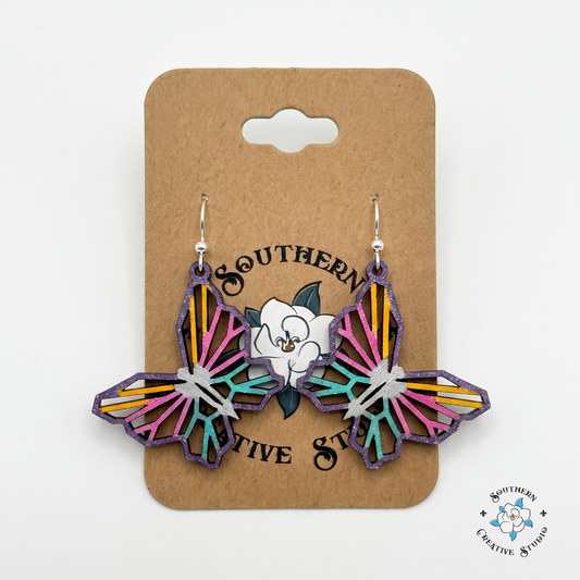 Colorful geometric butterfly wood earrings on Southern Creative Studio hang card