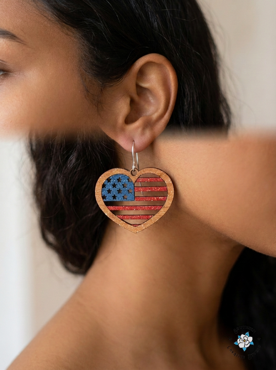 Woman wearing American flag heart dangle earring with silver hook close-up