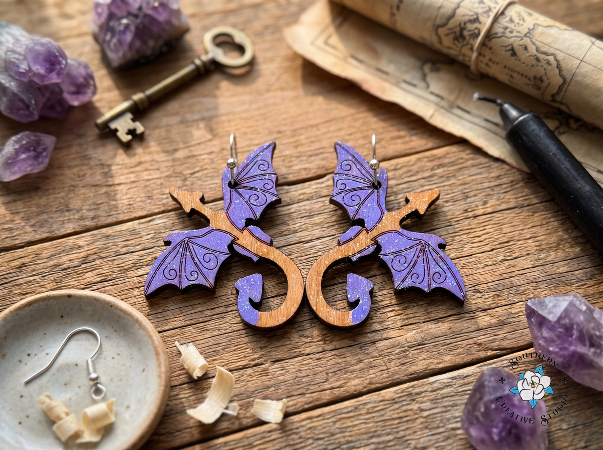Purple dragon wood earrings on rustic table with amethyst crystals, antique key and parchment map