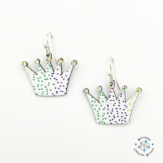 Mardi Gras crown earrings, jeweled white crown dangles with purple and green speckles on white background