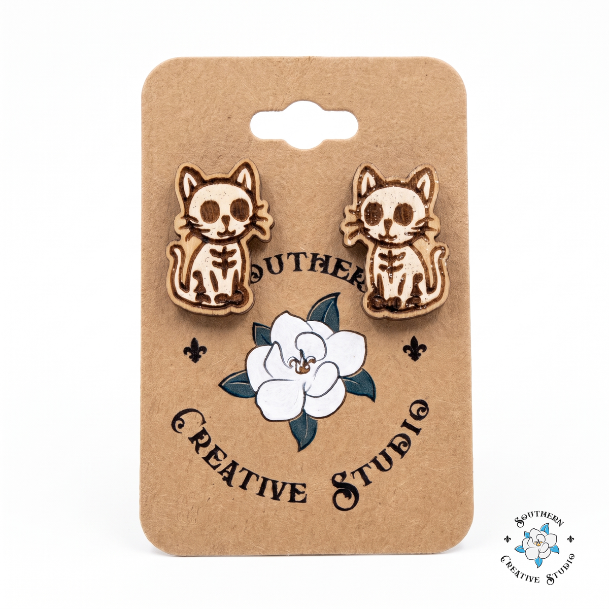 White skeleton cat wood stud earrings on Southern Creative Studio hang card