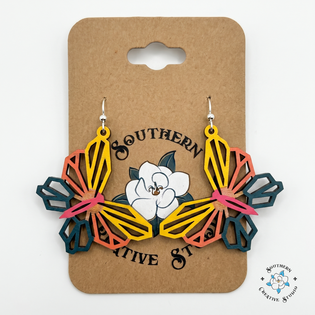 Yellow and coral geometric butterfly wood earrings on Southern Creative Studio hang card