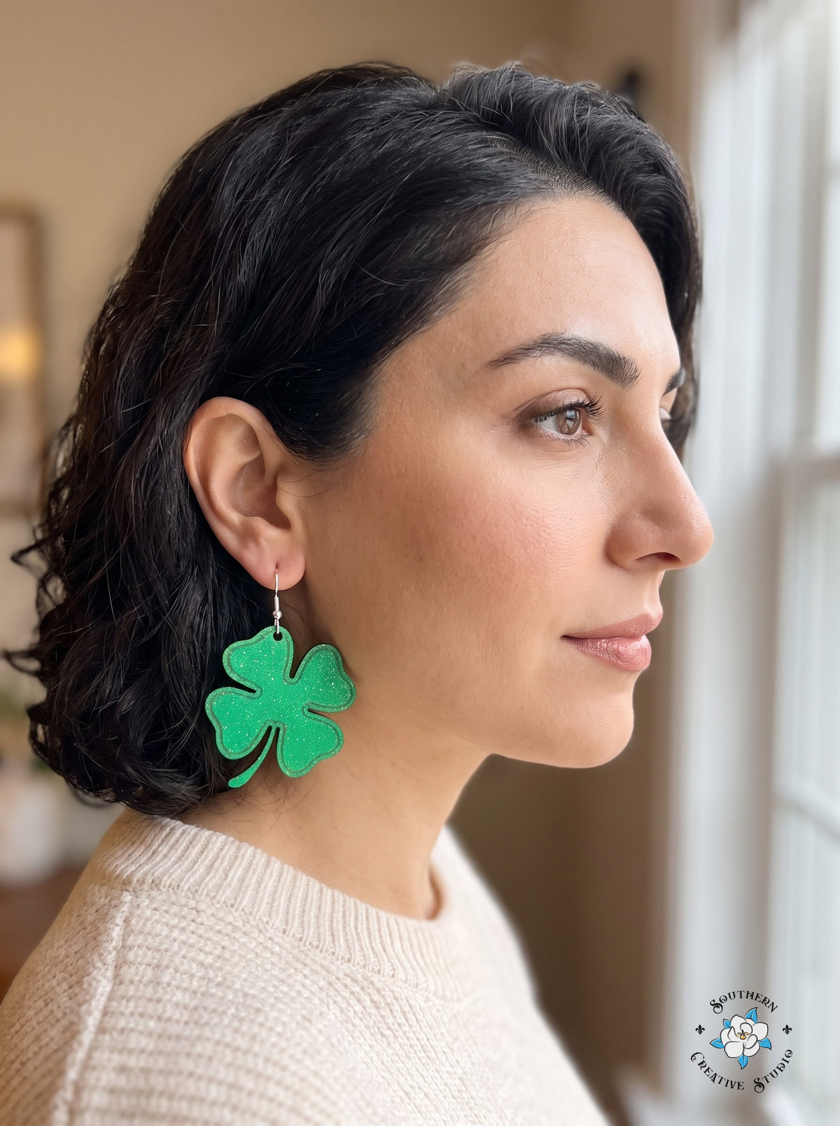 Woman wearing large simple four leaf clover earrings