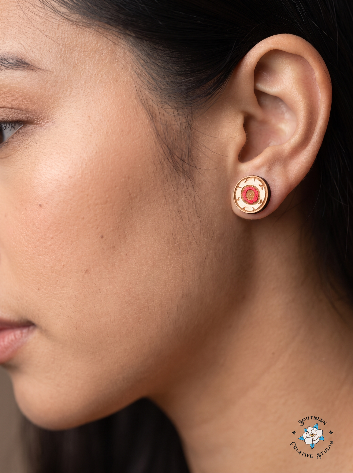 Close-up of red eyeball wood stud earring worn in ear