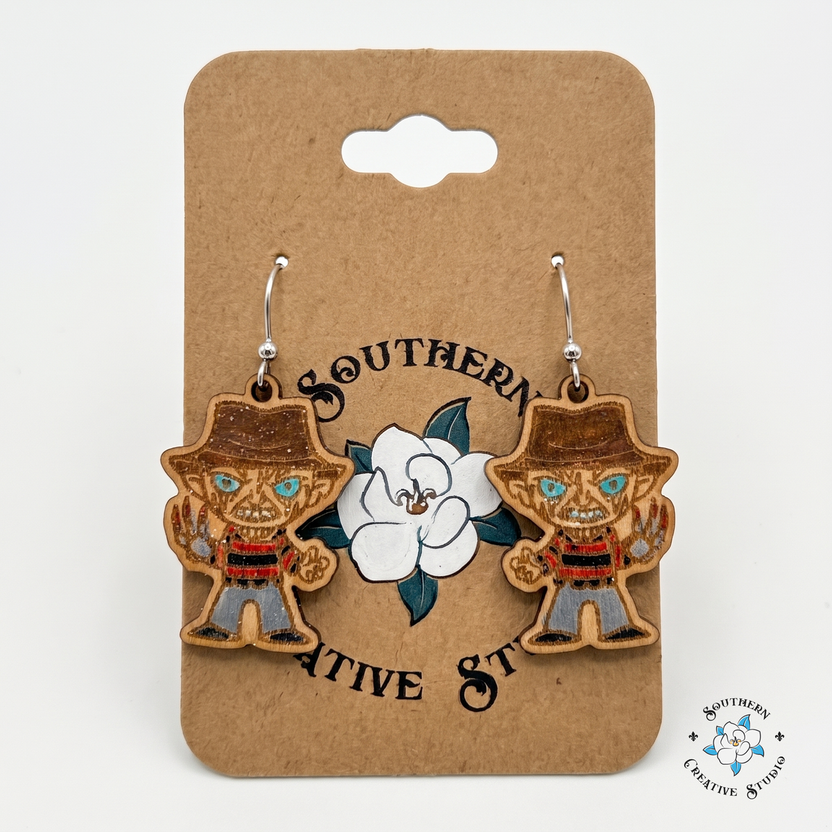 Hand-painted slasher horror earrings on Southern Creative Studio kraft hang card