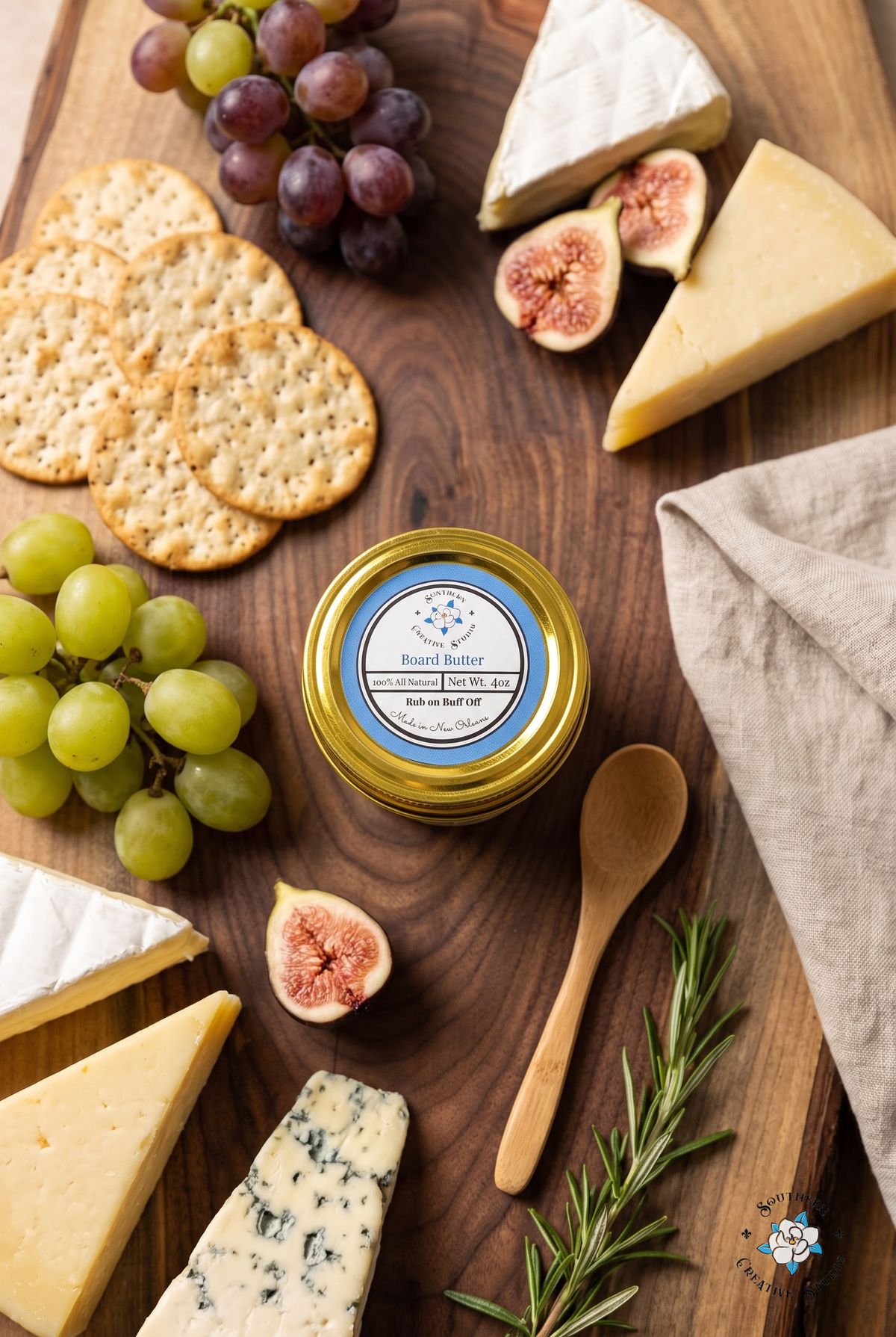 Board Butter on a walnut charcuterie board with cheese, figs and grapes