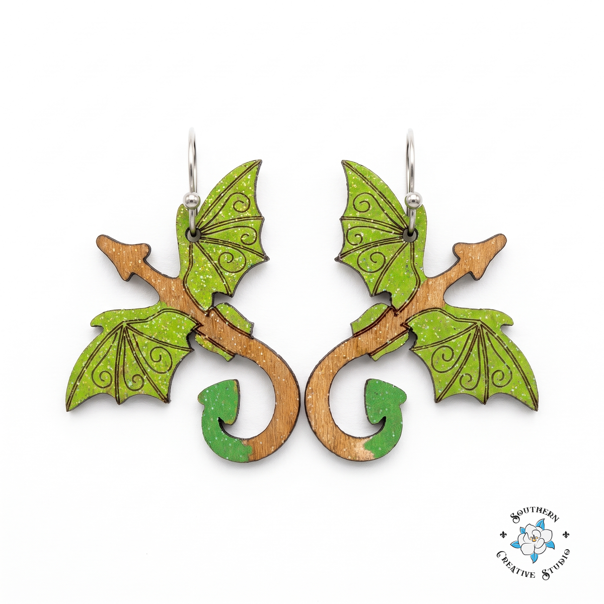 Green dragon hand-painted wood dangle earrings with lime wings on white background
