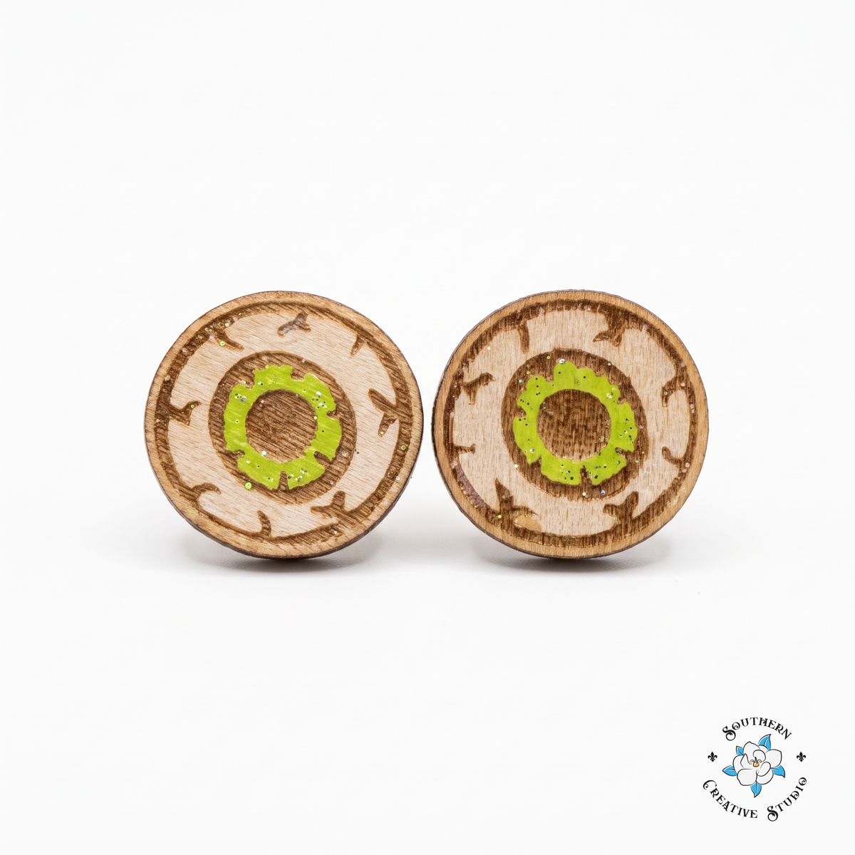 Green eyeball stud earrings, hand-painted wood, on white background