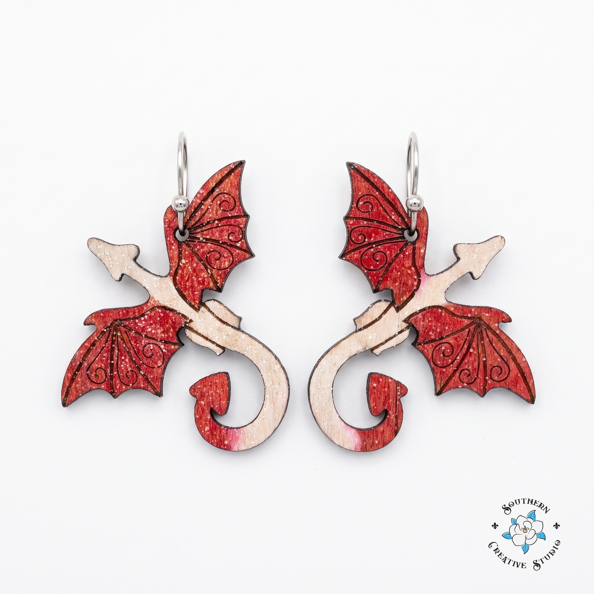 Red dragon hand-painted wood dangle earrings with crimson wings on white background