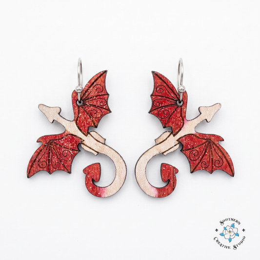 Red dragon hand-painted wood dangle earrings with crimson wings on white background