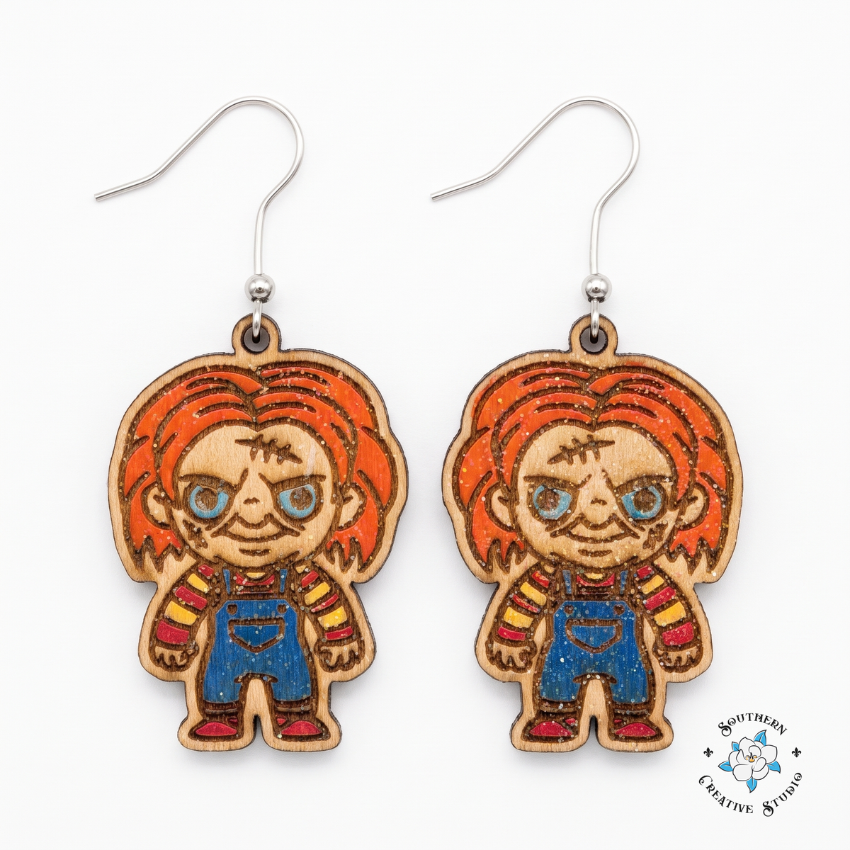 Hand-painted wood killer doll dangle earrings with orange hair on white background