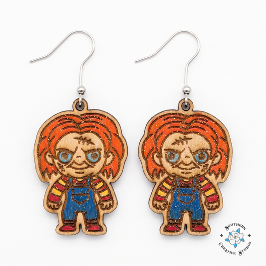 Hand-painted wood killer doll dangle earrings with orange hair on white background