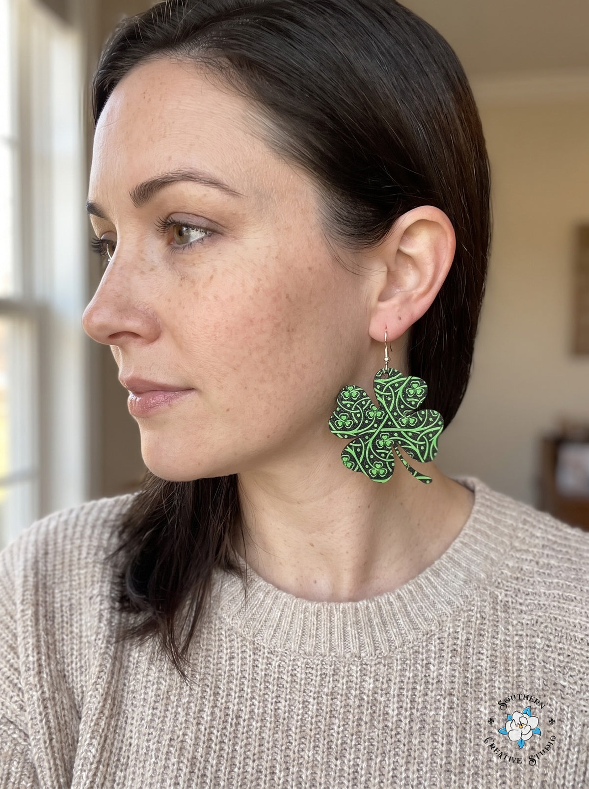 Woman wearing large Celtic knot four leaf clover earrings