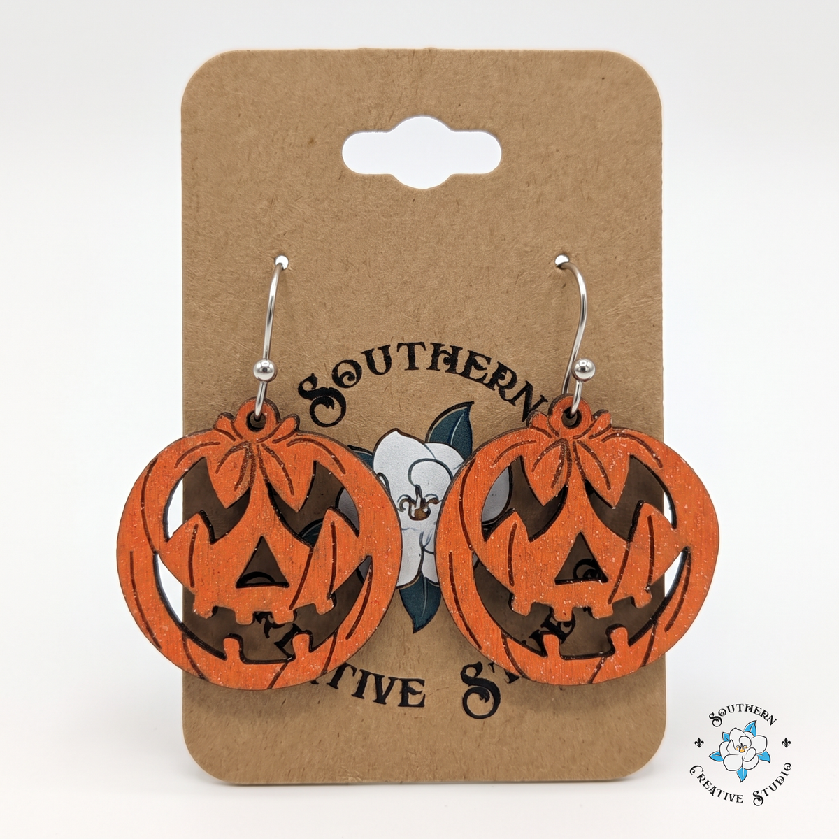 Jack-o'-lantern pumpkin earrings on Southern Creative Studio magnolia hang card