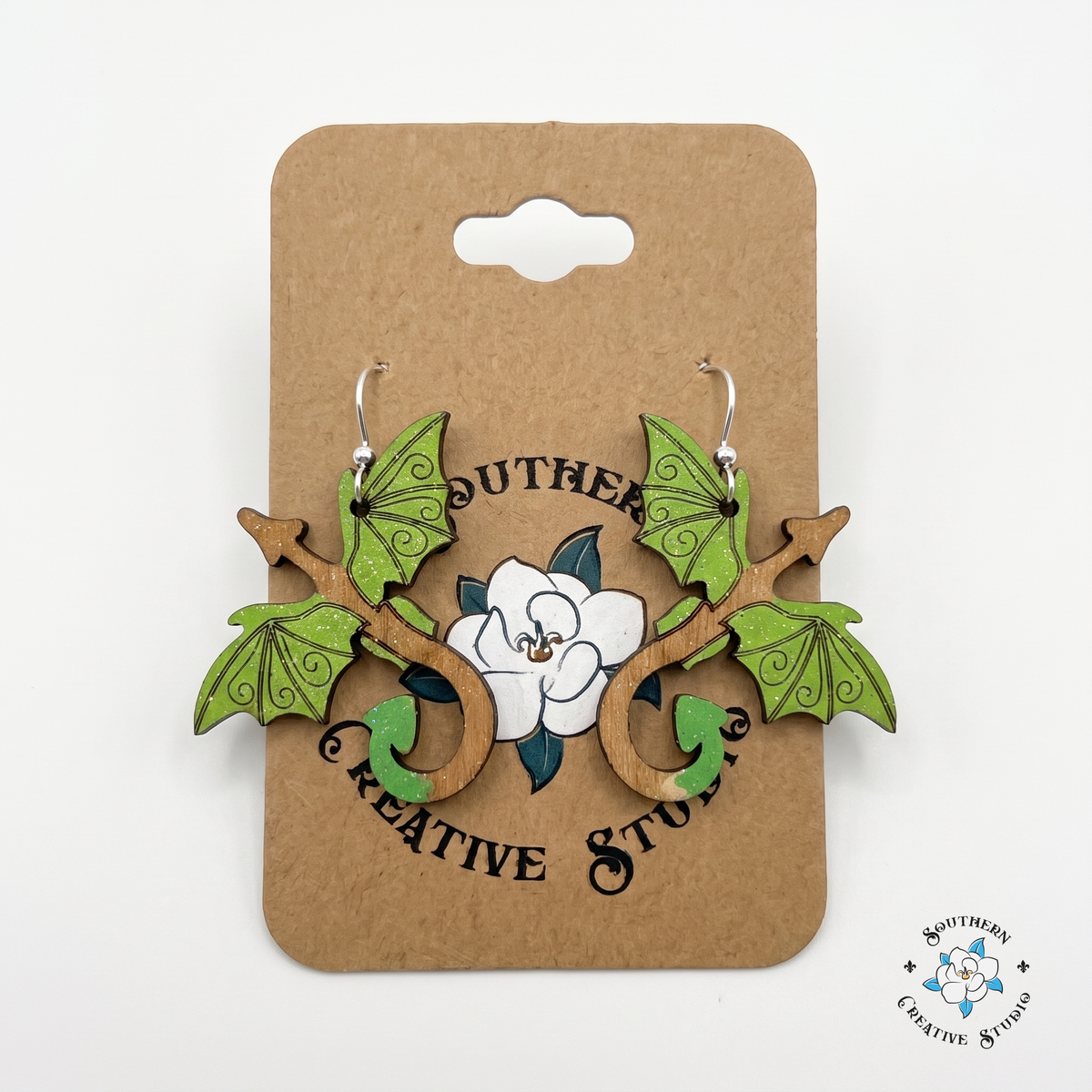 Hand-painted green dragon wood earrings on Southern Creative Studio kraft hang card
