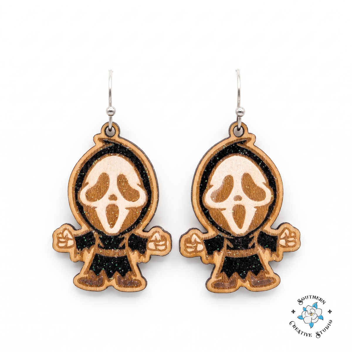 Hand-painted wood screaming ghost mask dangle earrings on white background
