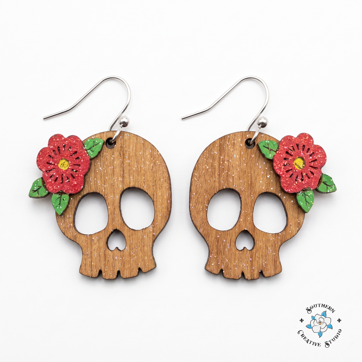 Red flower skull earrings hand-painted wood on white background