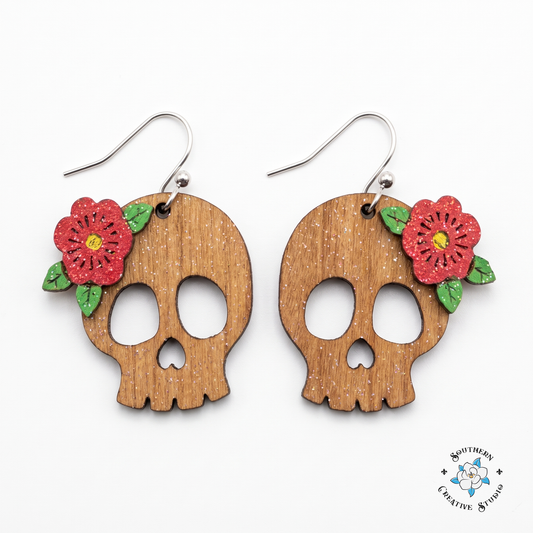 Red flower skull earrings hand-painted wood on white background