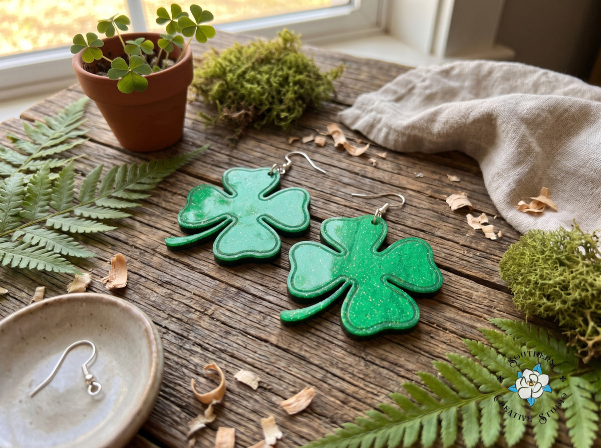 Large four leaf clover earrings styled with ferns, moss and shamrocks