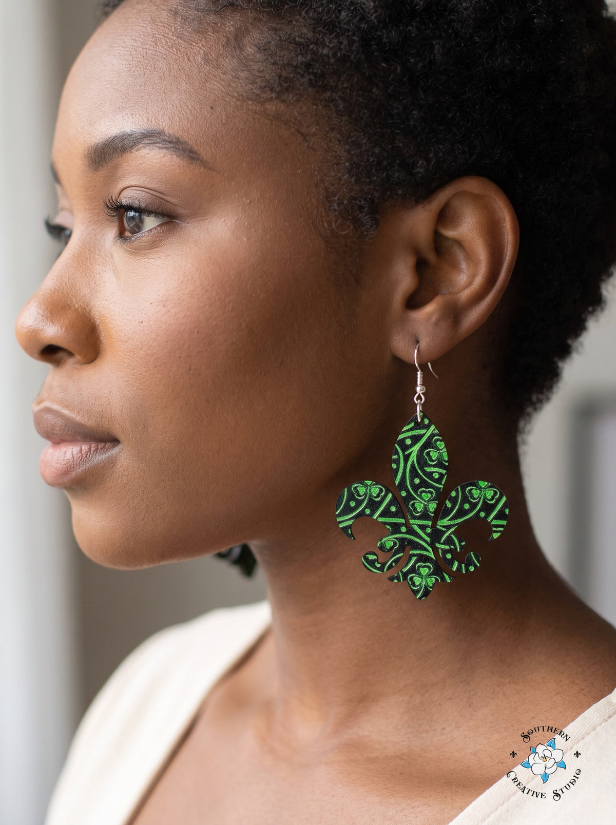 Woman wearing dark green Celtic knot fleur-de-lis dangle earrings