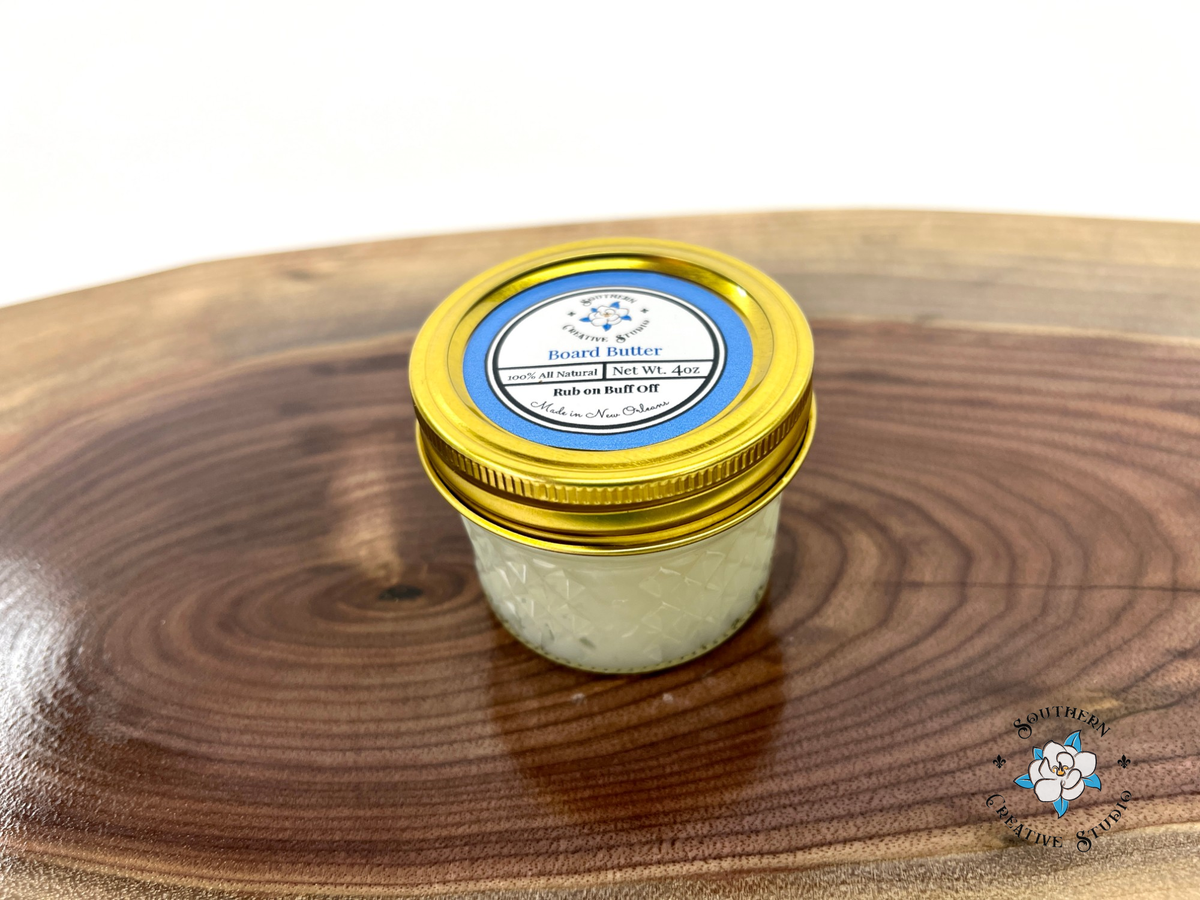 Board Butter 4 oz jar with gold lid on live-edge walnut board
