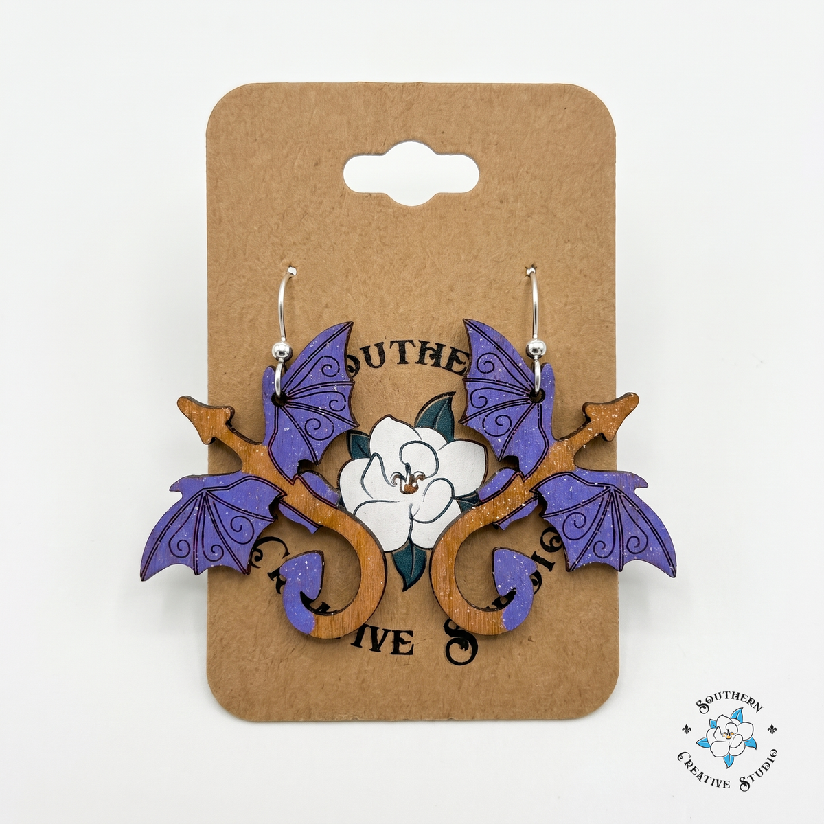 Hand-painted purple dragon wood earrings on Southern Creative Studio kraft hang card