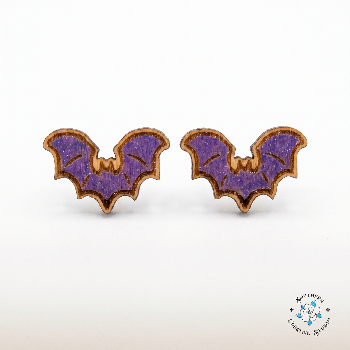 Purple bat wood stud earrings, hand-painted, on white background