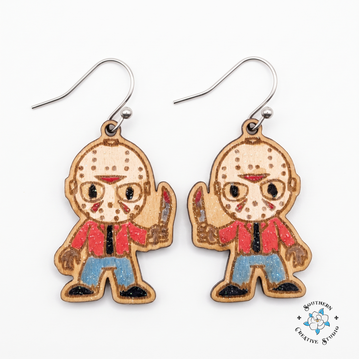 Hand-painted wood hockey mask slasher dangle earrings on white background