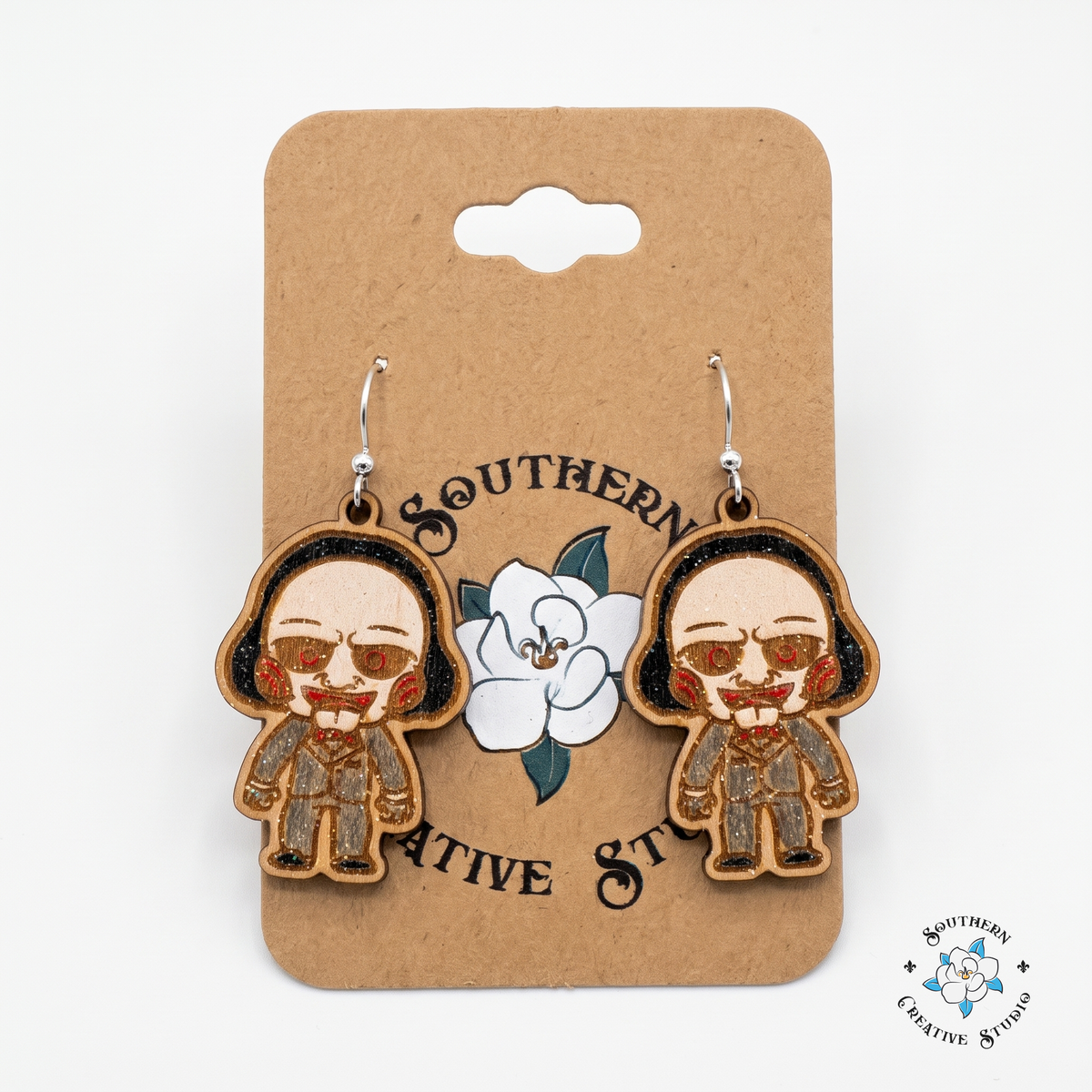 Hand-painted horror puppet earrings on Southern Creative Studio kraft hang card