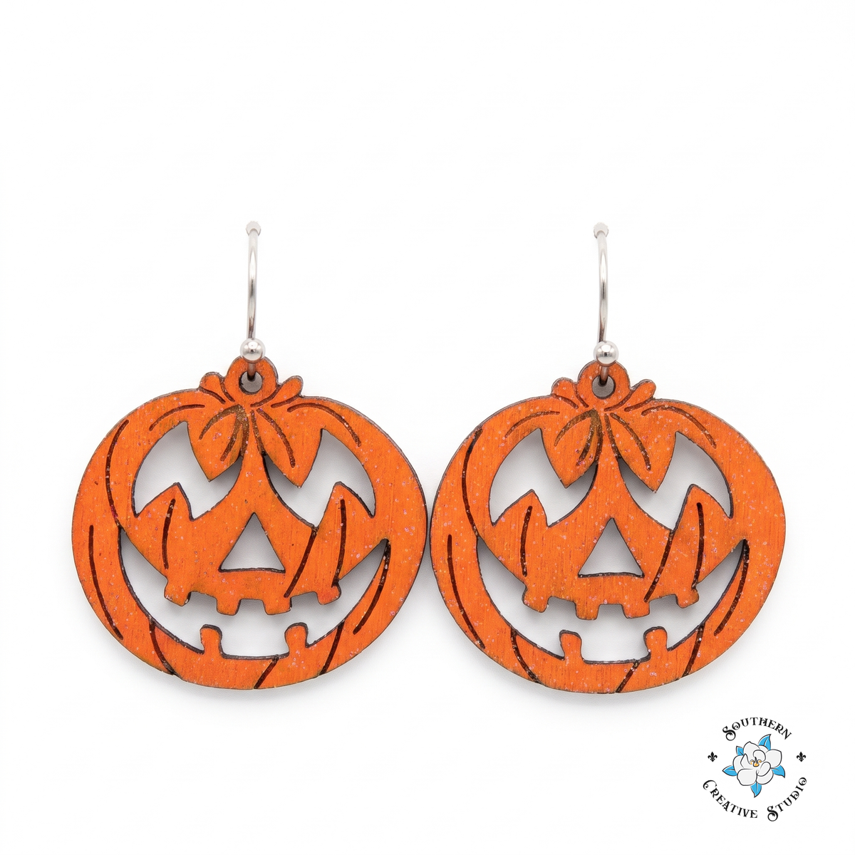 Hand-painted wood jack-o'-lantern dangle earrings on white background