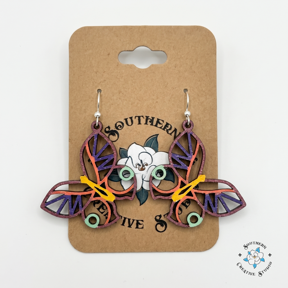 Colorful layered butterfly wood earrings on Southern Creative Studio hang card