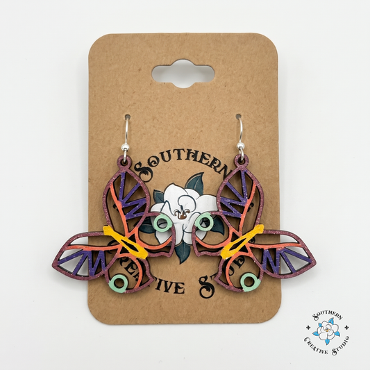 Colorful layered butterfly wood earrings on Southern Creative Studio hang card