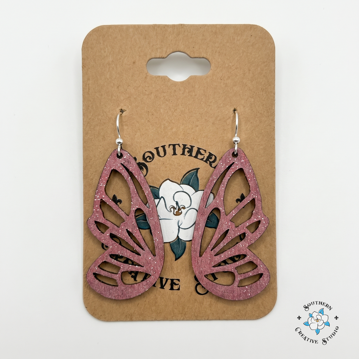 Pink butterfly wing wood earrings on Southern Creative Studio hang card