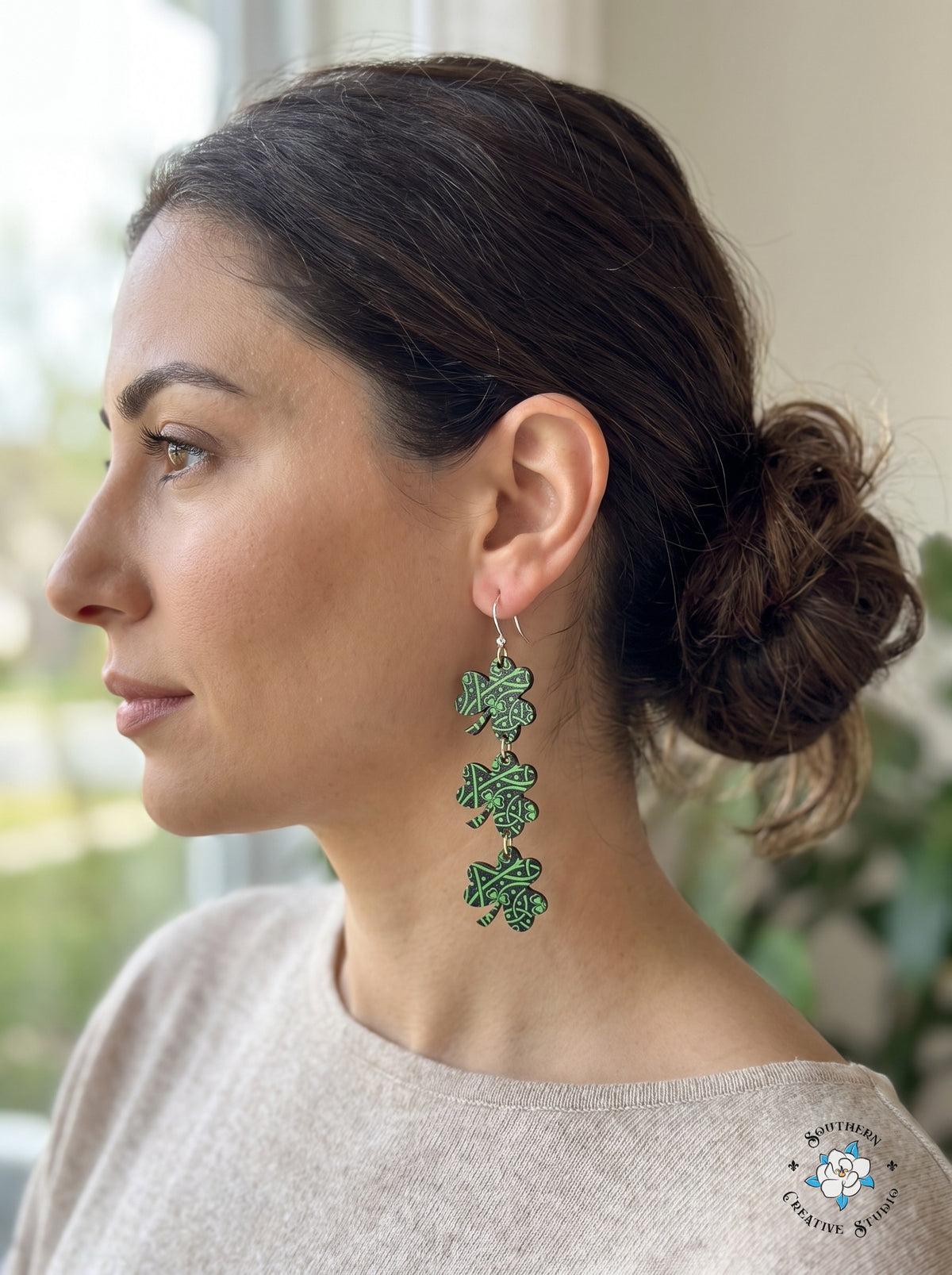 Woman wearing long Celtic knot three leaf clover dangle earrings
