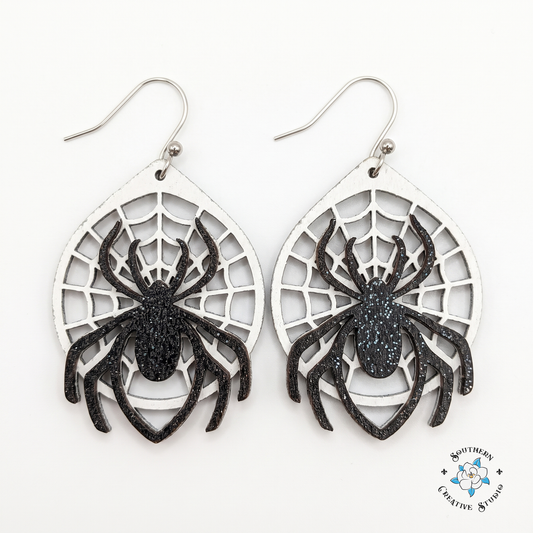 Layered wood spider web dangle earrings, hand-painted, on white background