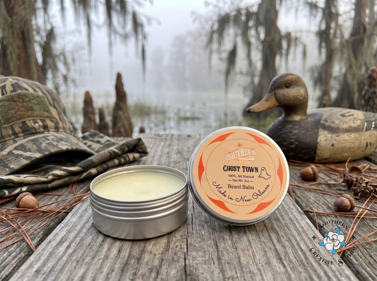 Ghost Town beard balm by Southern Creative Studio, open tin and lid with a misty Louisiana marsh with camo, a duck decoy and Spanish moss