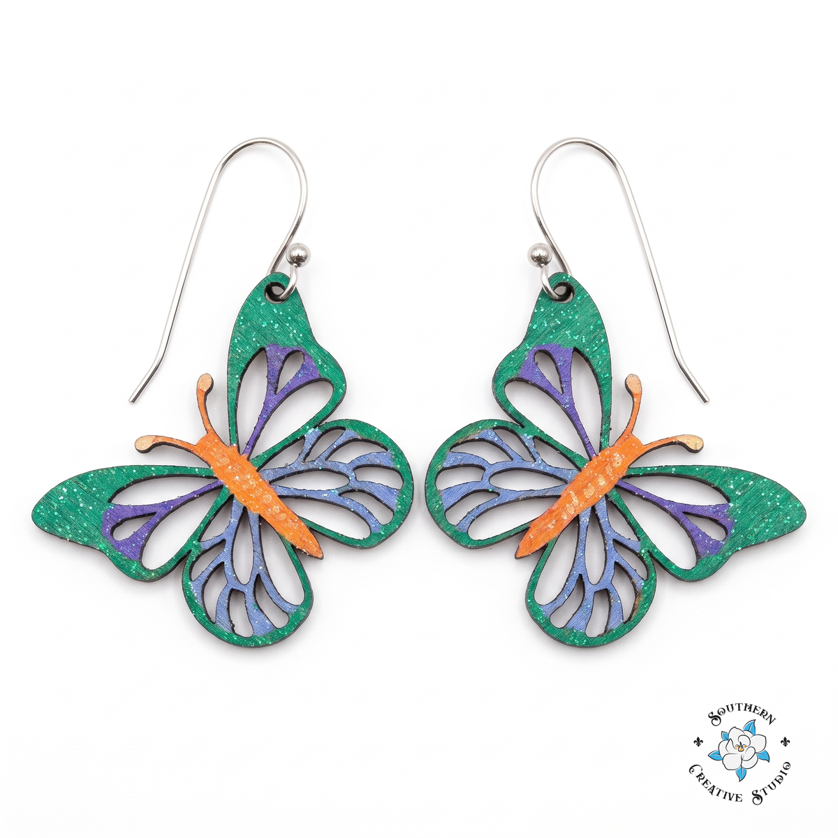 Emerald green butterfly earrings with purple and blue veining, hand-painted wood dangles on white background
