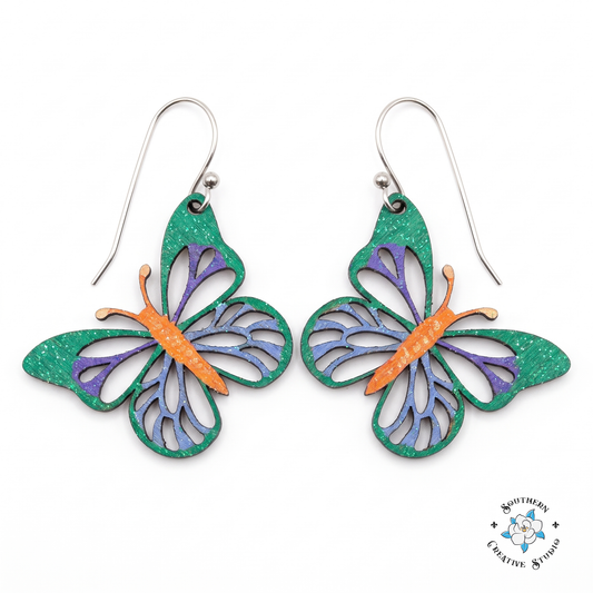 Emerald green butterfly earrings with purple and blue veining, hand-painted wood dangles on white background