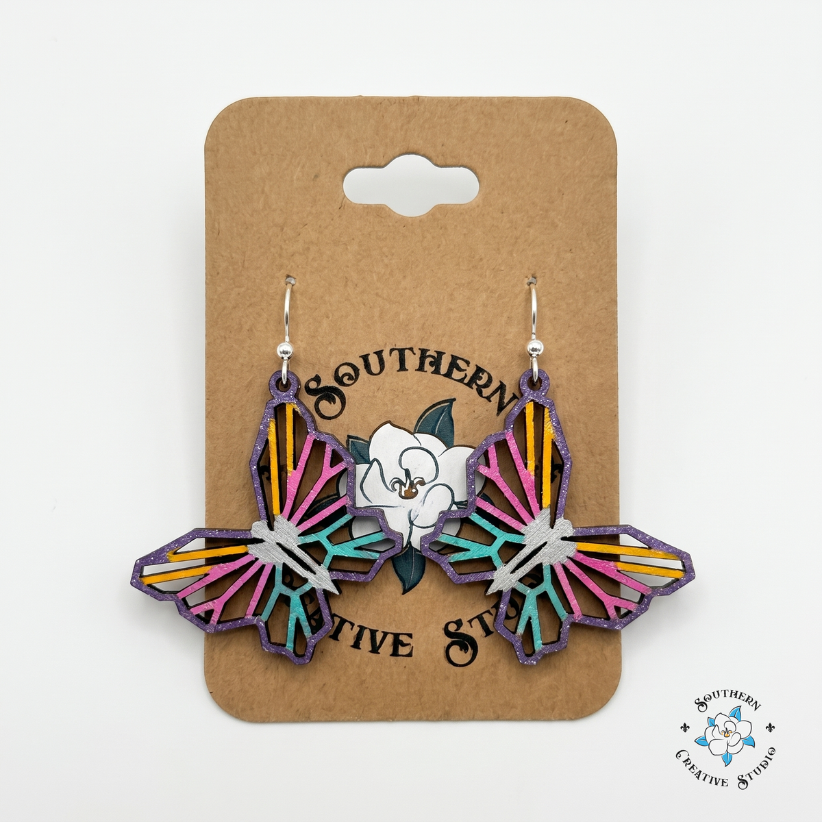 Colorful geometric butterfly wood earrings on Southern Creative Studio hang card