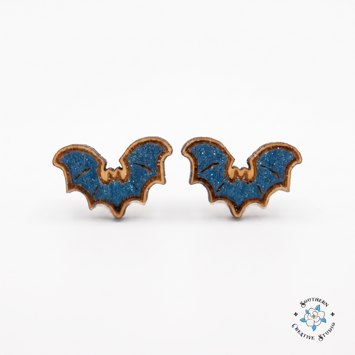 Blue bat wood stud earrings, hand-painted, on white background