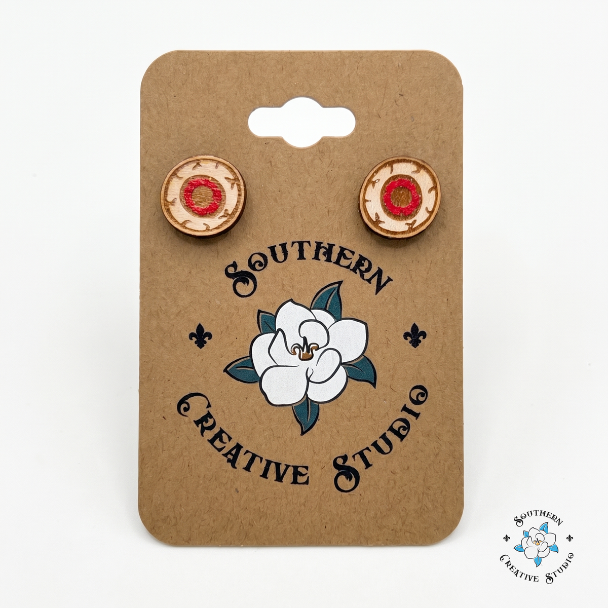 Red eyeball wood stud earrings on Southern Creative Studio hang card