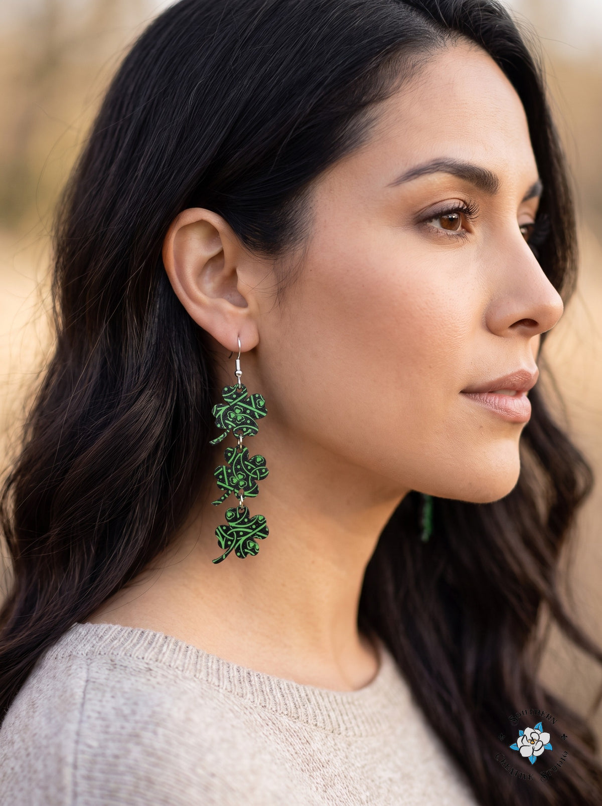 Woman wearing long Celtic knot four leaf clover dangle earrings