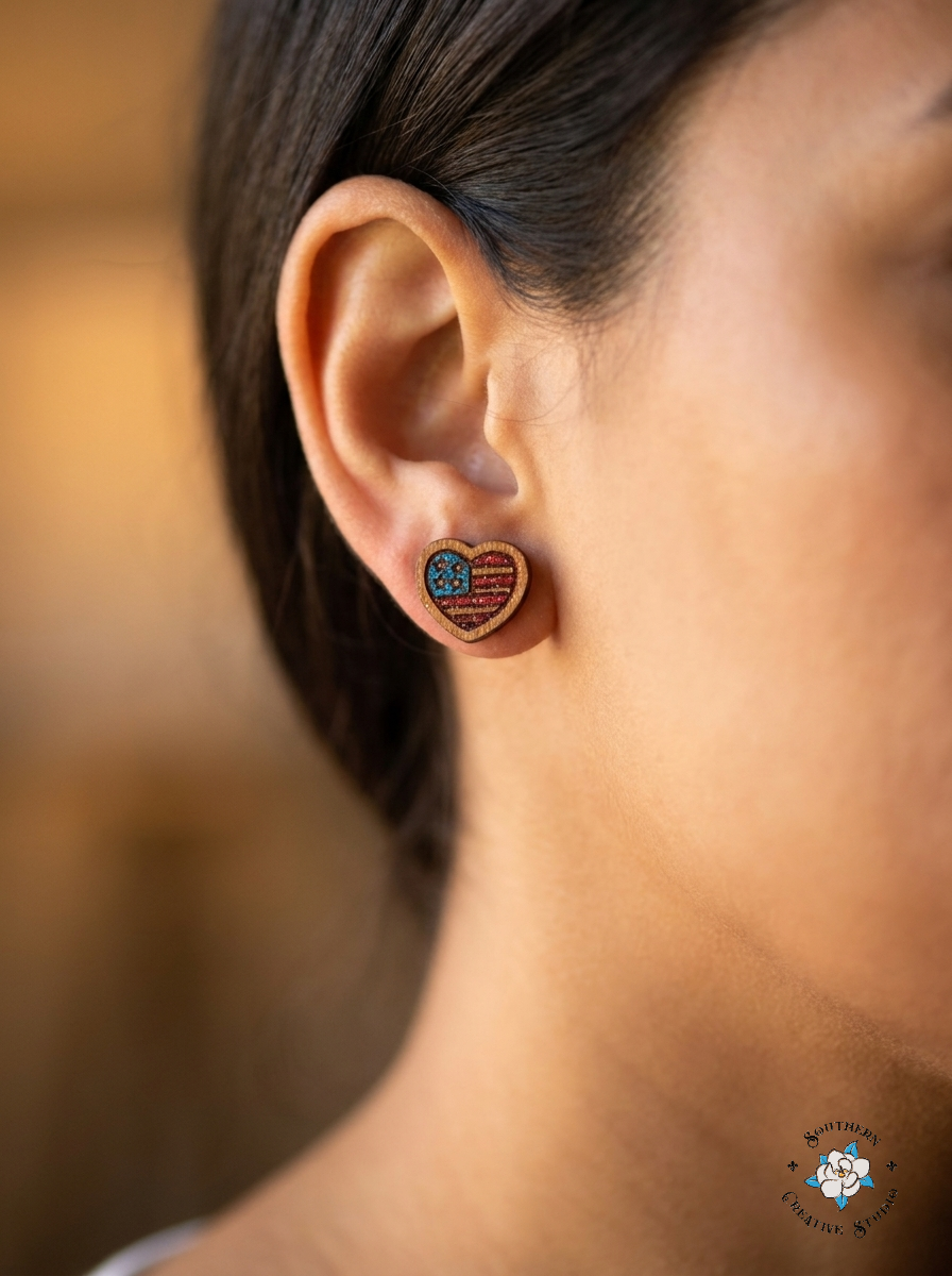 Close up of American Flag Heart hand-painted wood stud earring on ear