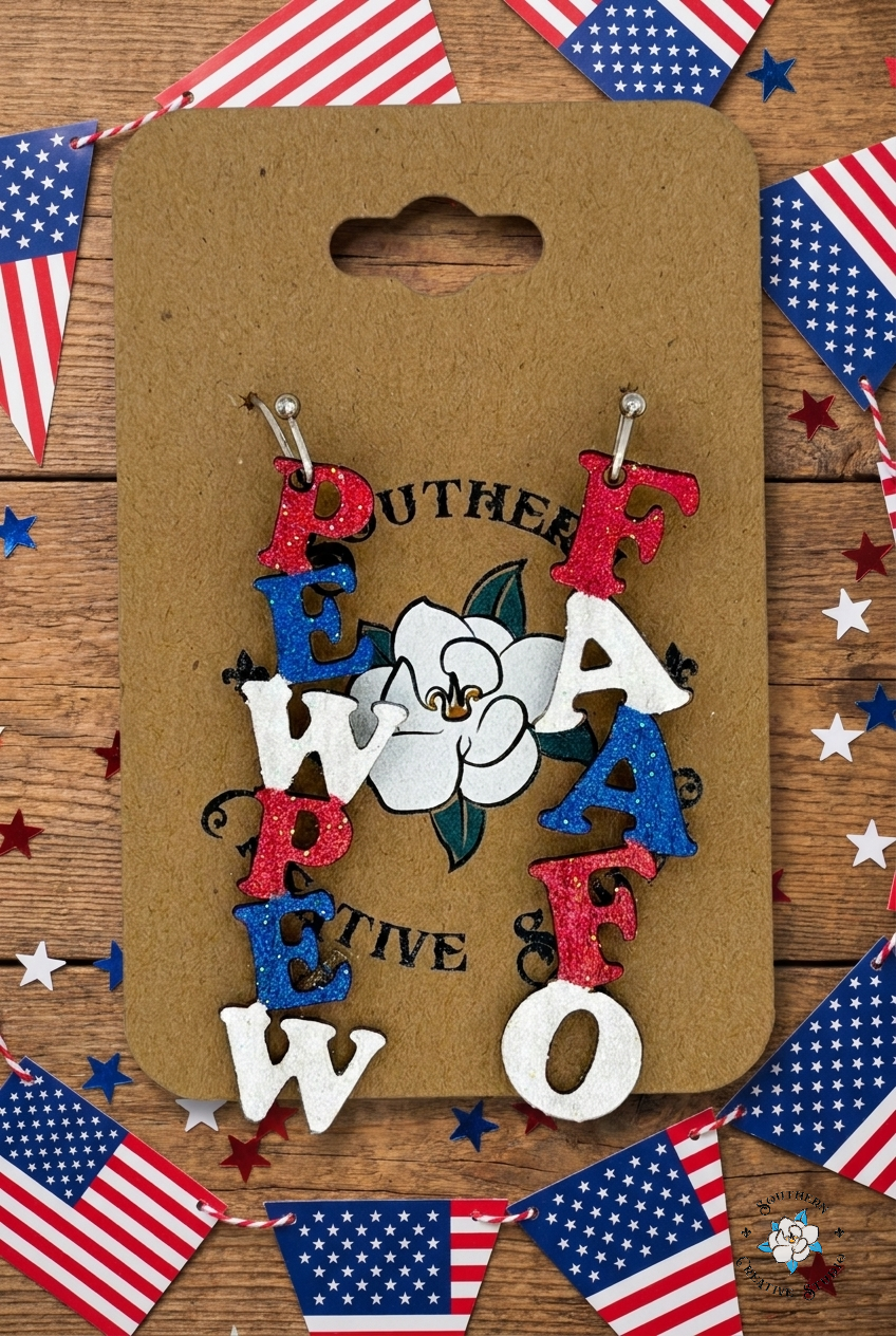 Flat lay moodboard of PEWPEW FAAFO hand-painted wood earrings on Southern Creative Studio card