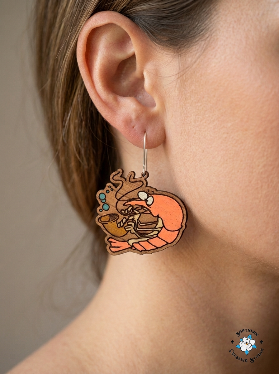 Close up of Silly Shrimp hand-painted wood earring on ear