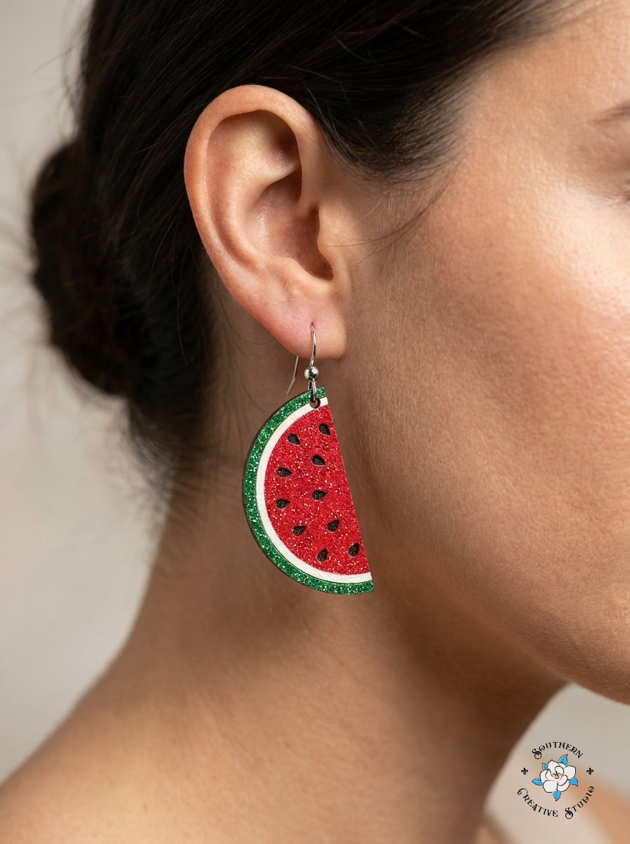 Close up of Watermelon Slice hand-painted wood earring on ear